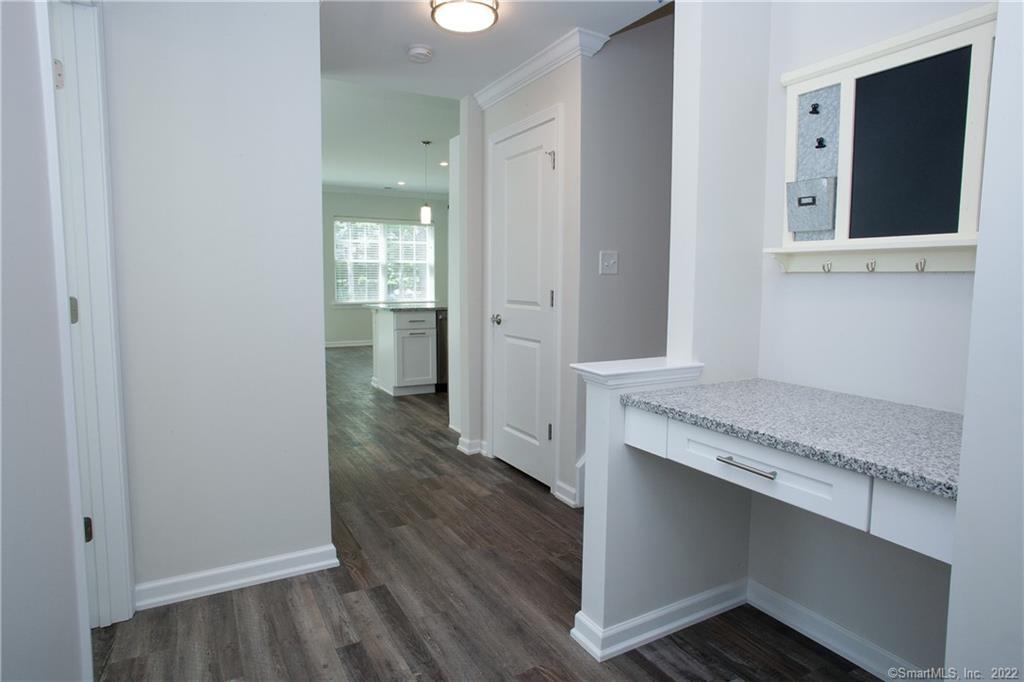 a room with granite countertop cabinets and wooden floor