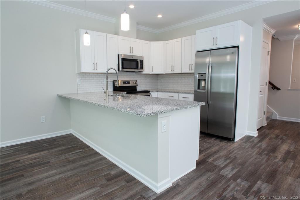 2 Murthas Way Granby, CT 06035 - Photo 13 of 28 a kitchen with kitchen island granite countertop a sink cabinets and stainless steel appliances