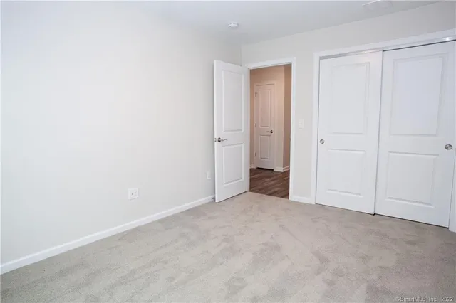 a view of an empty room and closet area