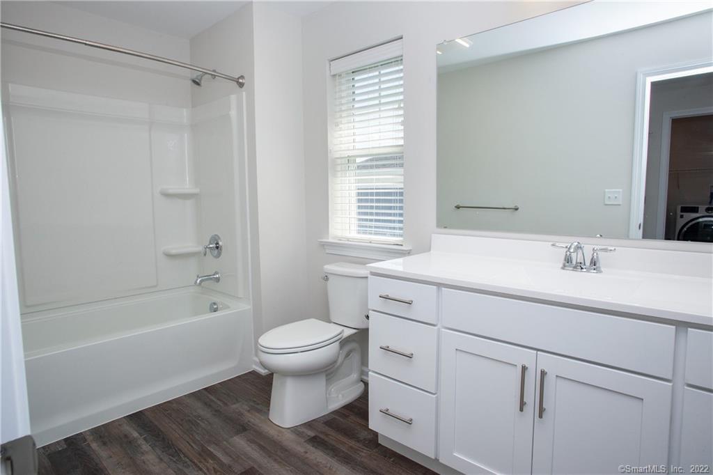 2 Murthas Way Granby, CT 06035 - Photo 19 of 28 a bathroom with a sink toilet a mirror and shower