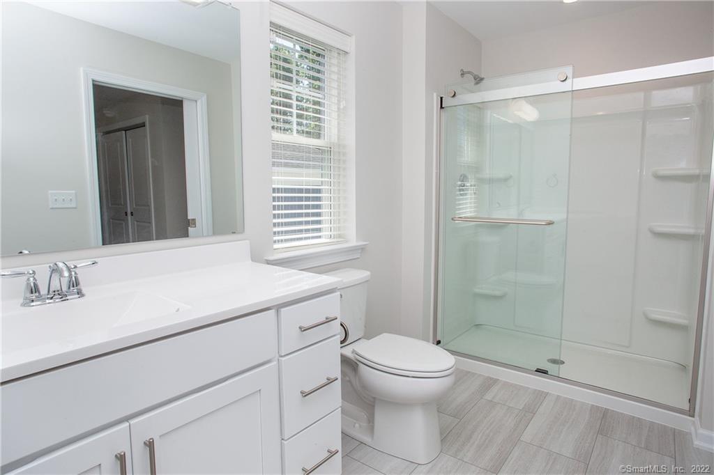 2 Murthas Way Granby, CT 06035 - Photo 25 of 28 a bathroom with a sink a toilet and shower