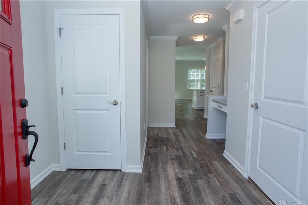 2 Murthas Way Granby, CT 06035 - Photo 3 of 28 a view of a hallway with wooden floor and a bathroom