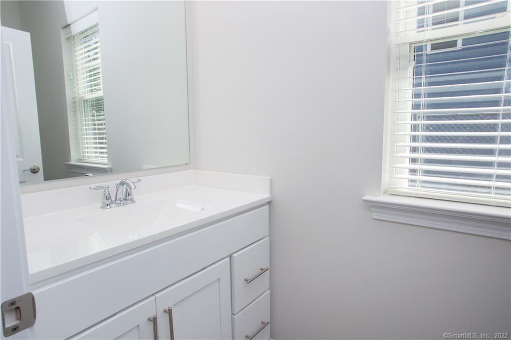 2 Murthas Way Granby, CT 06035 - Photo 6 of 28 a bathroom with a sink and a mirror