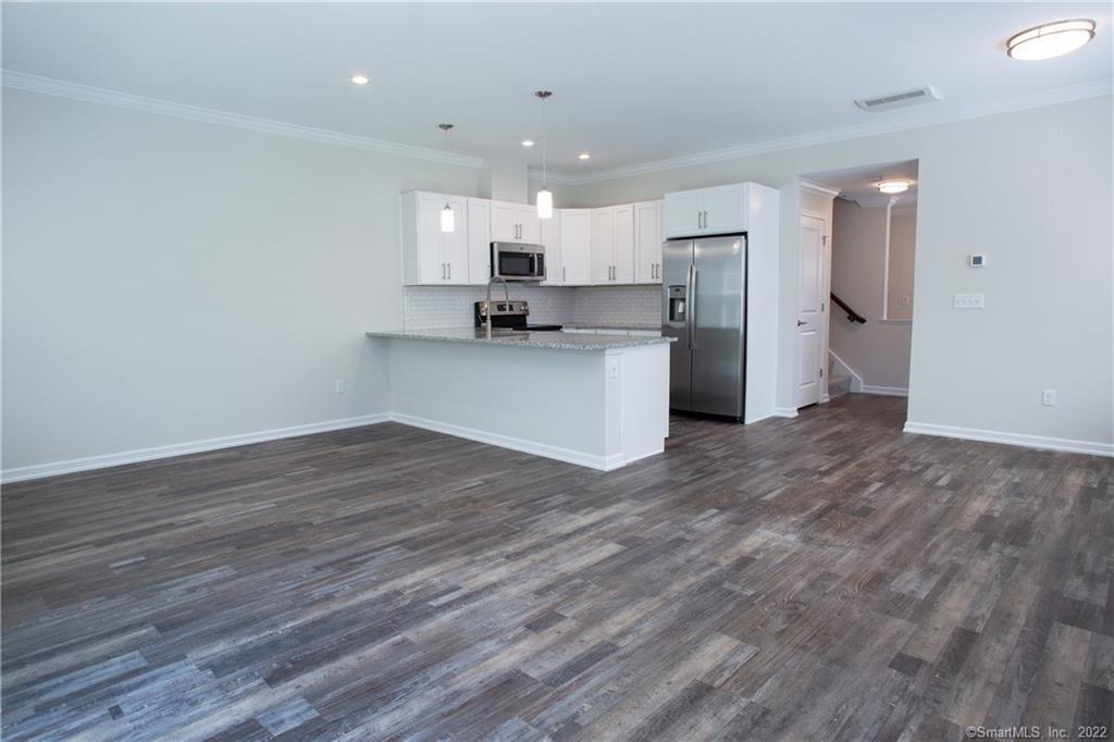 2 Murthas Way Granby, CT 06035 - Photo 9 of 28 a view of kitchen with wooden floor and electronic appliances