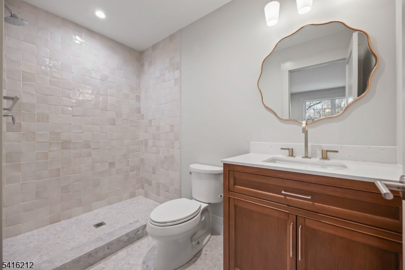 1209 Littleton Road, Unit E Morris Plains, NJ 07950 - Photo 18 of 27 a bathroom with a sink a toilet and shower
