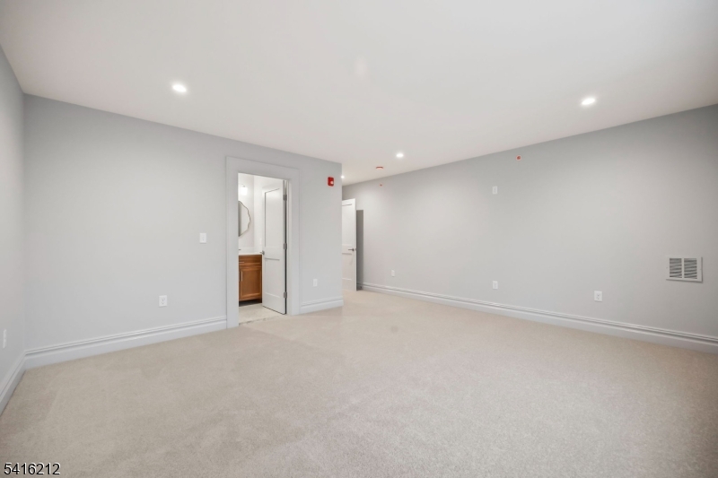 1209 Littleton Road, Unit E Morris Plains, NJ 07950 - Photo 20 of 27 an empty room with an entryway