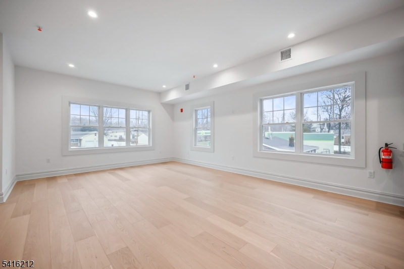 1209 Littleton Road, Unit E Morris Plains, NJ 07950 - Photo 2 of 27 an empty room with windows and entrance