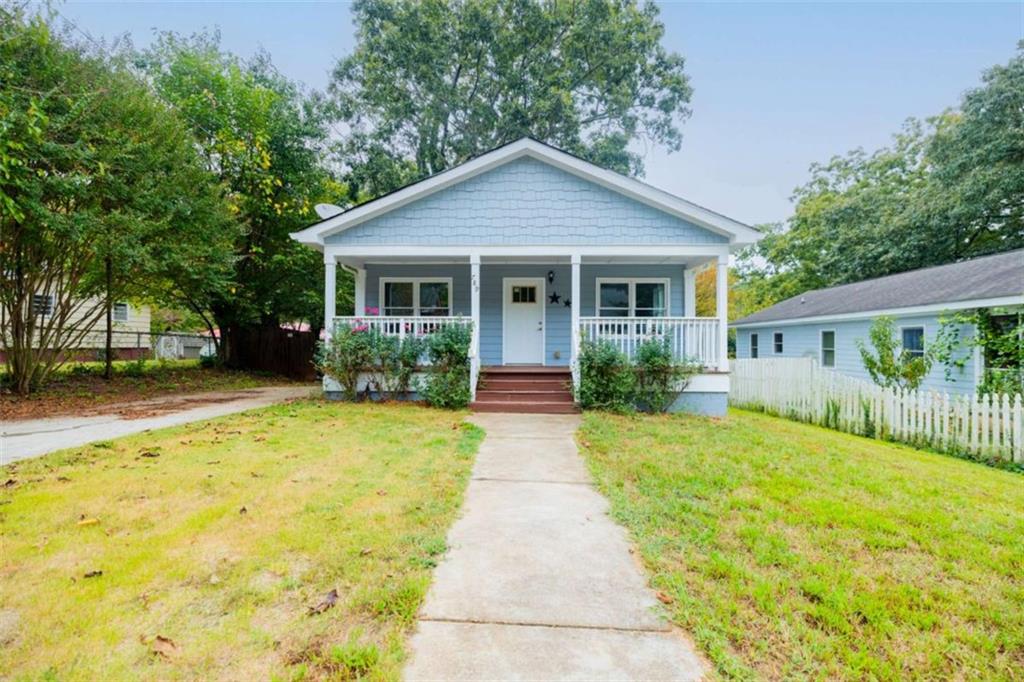 a view of house that has a yard