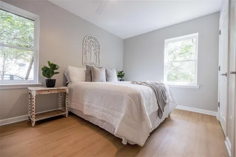 a bed sitting in a bedroom next to a window