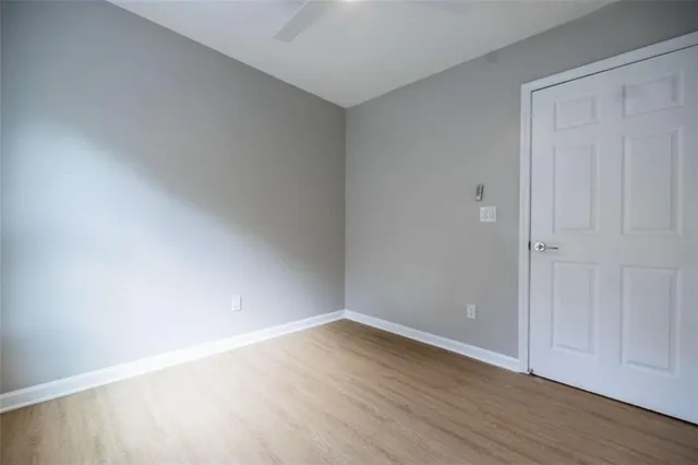 a view of an empty room with wooden floor