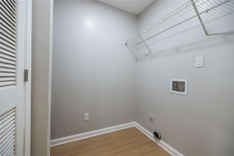 a view of a room with wooden floor