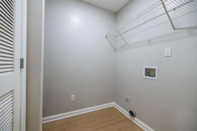 a view of a room with wooden floor