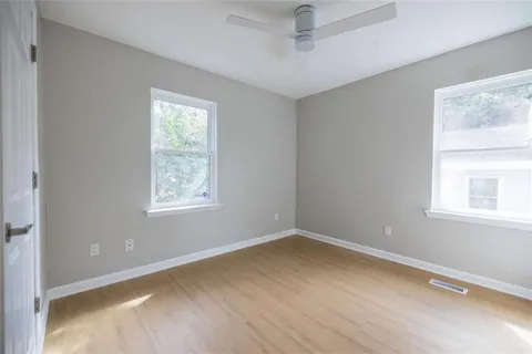 a view of a room with wooden floor and windows