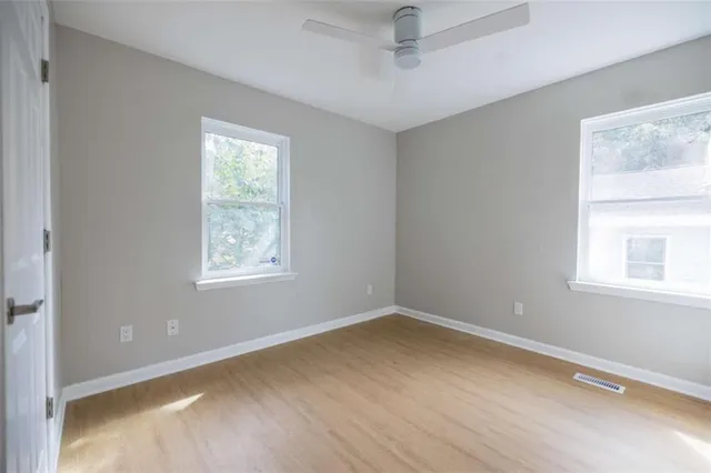 a view of a room with wooden floor and windows
