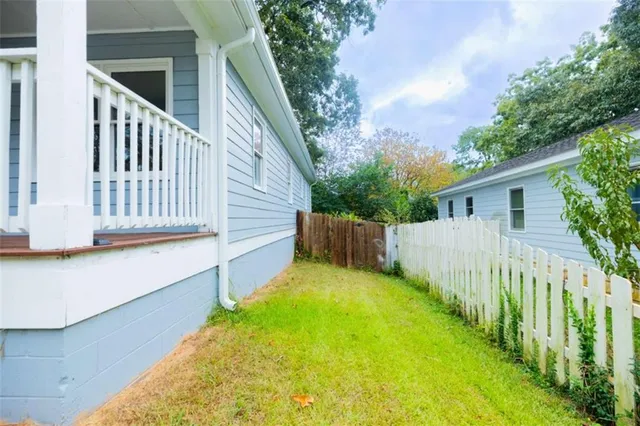 a view of a house with wooden fence