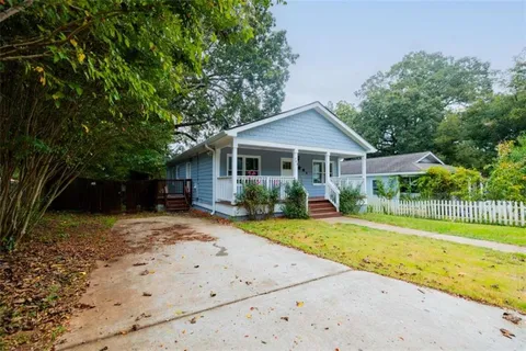 a front view of a house with a yard table and chairs