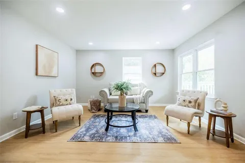 a living room with furniture rug and window