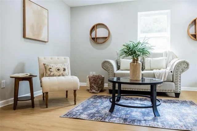 a living room with furniture a rug and a window