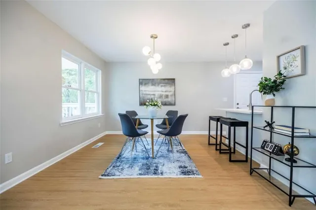 a view of a dining room with furniture window and wooden floor