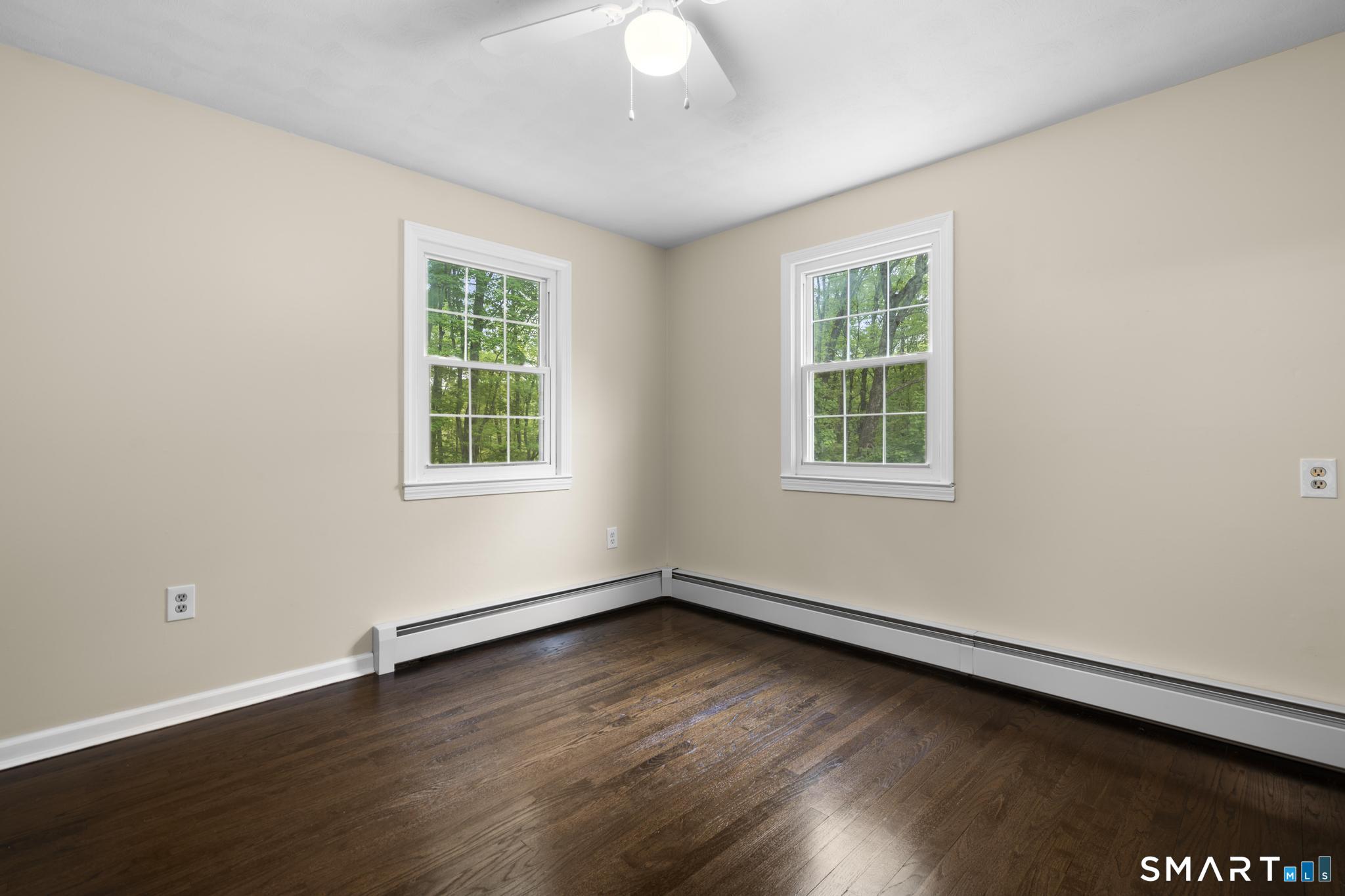 7 Sycamore Terrace Windham, CT 06280 - Photo 23 of 40 an empty room with wooden floor and windows