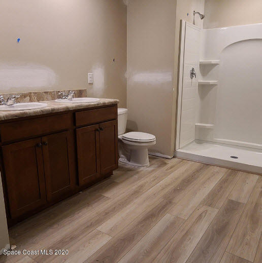 1179 Dania Circle Palm Bay, FL 32905 - Photo 10 of 11 a bathroom with a sink a toilet and shower