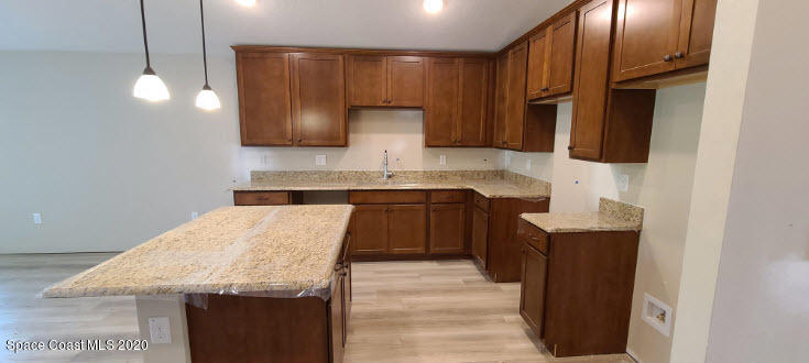 1179 Dania Circle Palm Bay, FL 32905 - Photo 4 of 11 a kitchen with stainless steel appliances granite countertop a sink stove and refrigerator