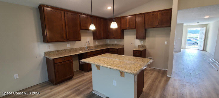 1179 Dania Circle Palm Bay, FL 32905 - Photo 5 of 11 a kitchen with a sink and a refrigerator