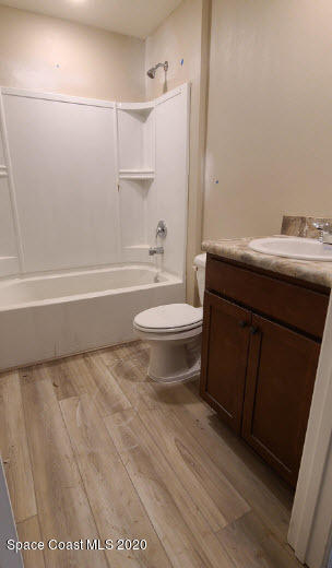1179 Dania Circle Palm Bay, FL 32905 - Photo 9 of 11 a bathroom with a sink a toilet and shower