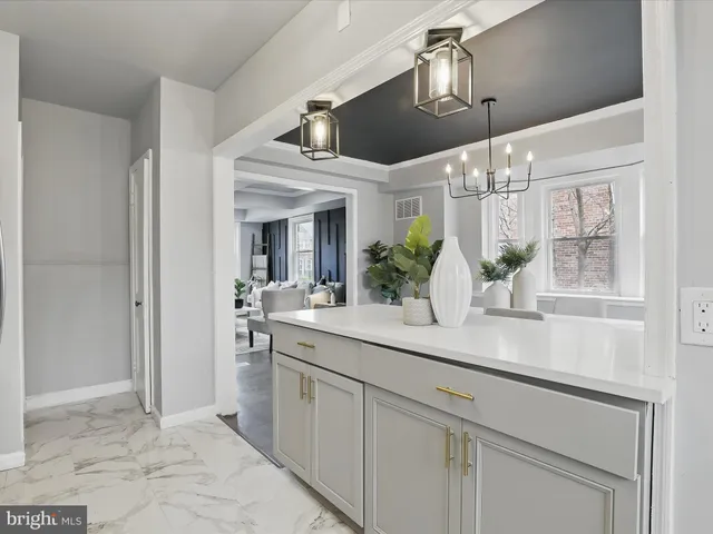 a kitchen with a sink a stove and cabinets