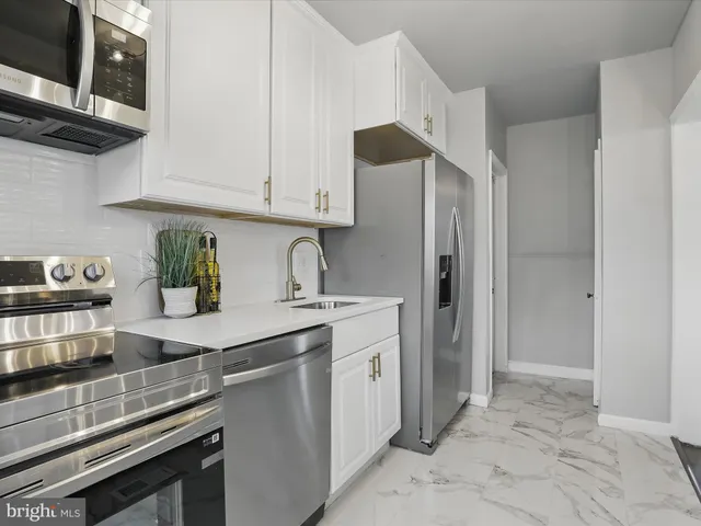 a view of living room and kitchen with a sink