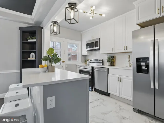 a kitchen with stainless steel appliances granite countertop a sink and cabinets