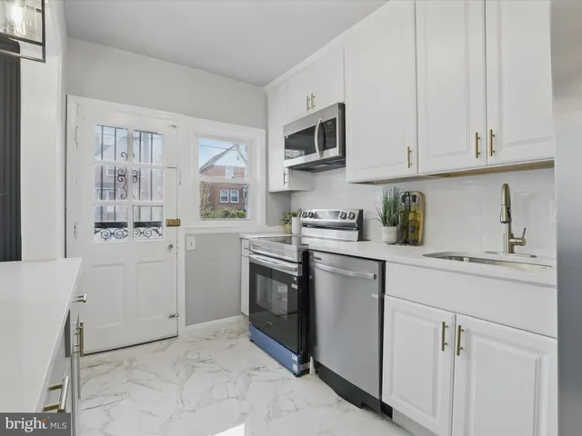 a kitchen with cabinets and stainless steel appliances