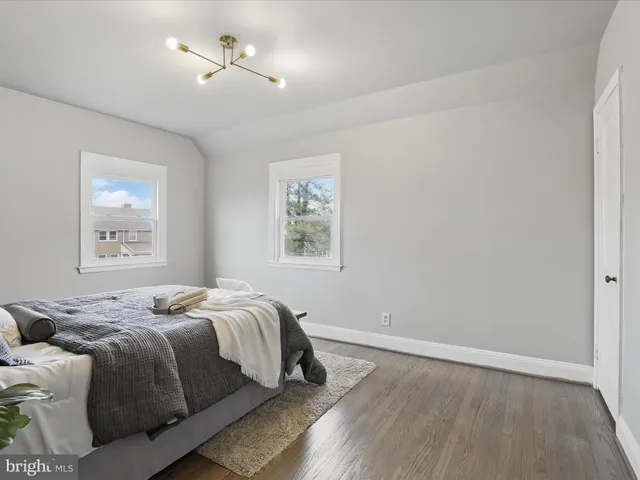 a bedroom with bed and wall painting