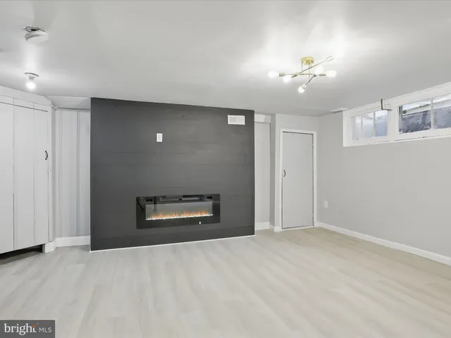 wooden floor in an empty room with a fireplace
