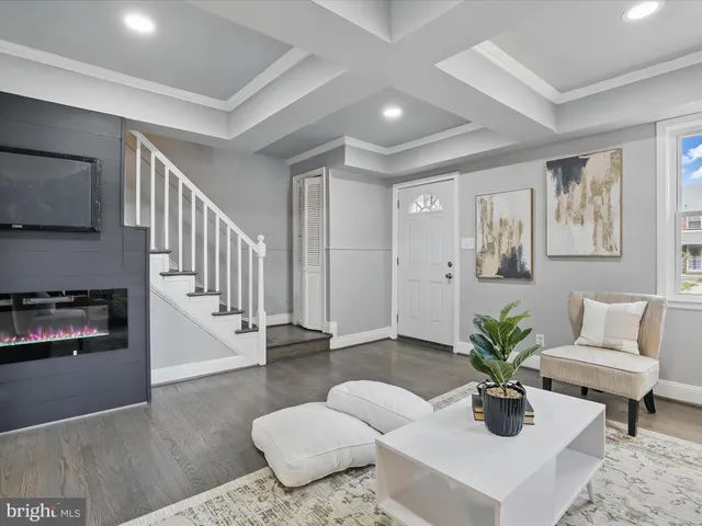 a living room with furniture potted plant and a fireplace