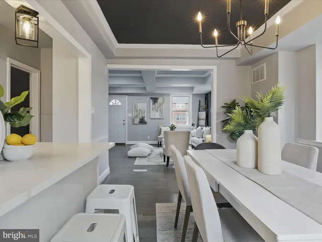 a dining room with furniture and potted plants