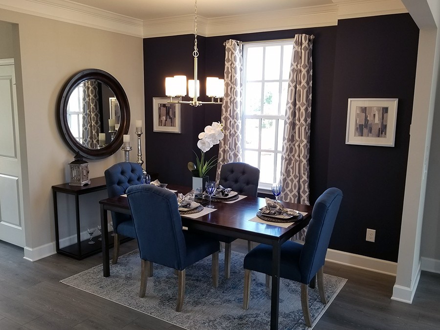 a dining room with furniture and a mirror
