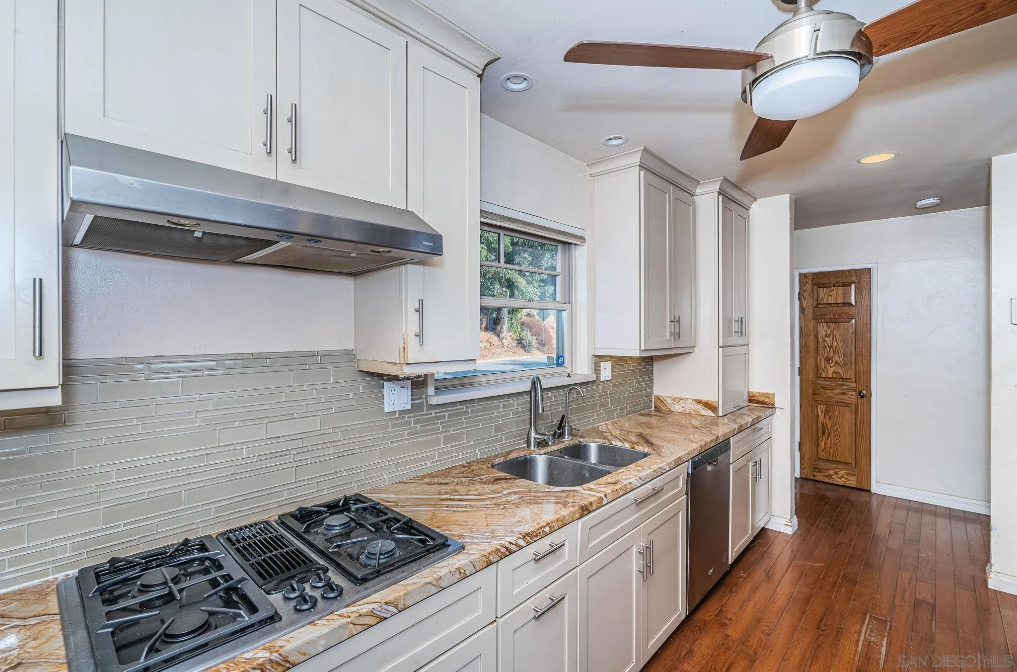 8046 Pasadena Avenue La Mesa, CA 91941 - Photo 12 of 32 a kitchen with stainless steel appliances granite countertop a sink stove and cabinets