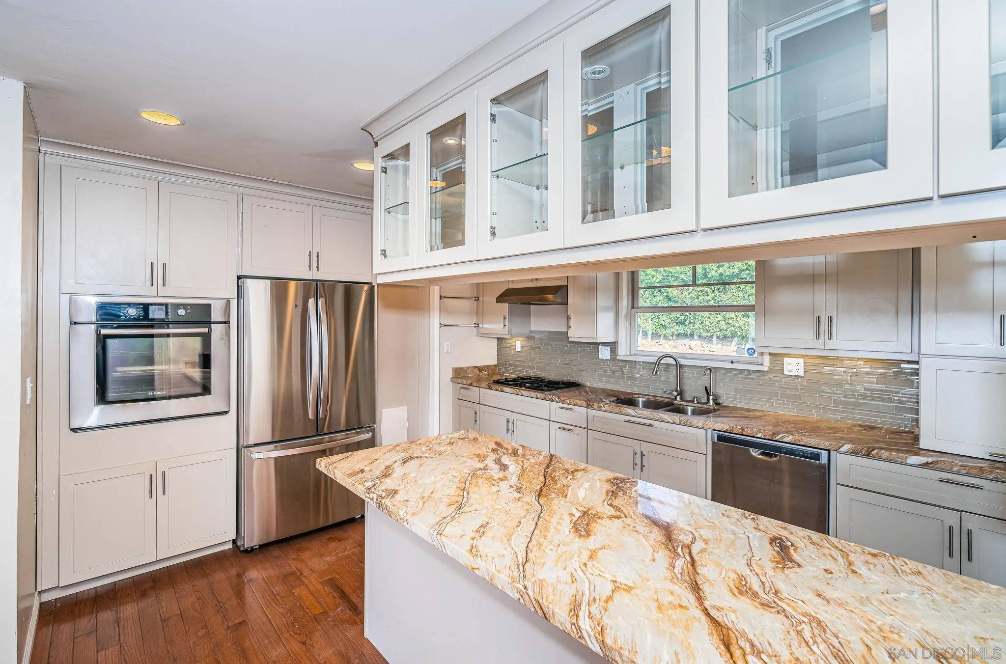 8046 Pasadena Avenue La Mesa, CA 91941 - Photo 14 of 32 a kitchen with stainless steel appliances granite countertop a sink stove and refrigerator