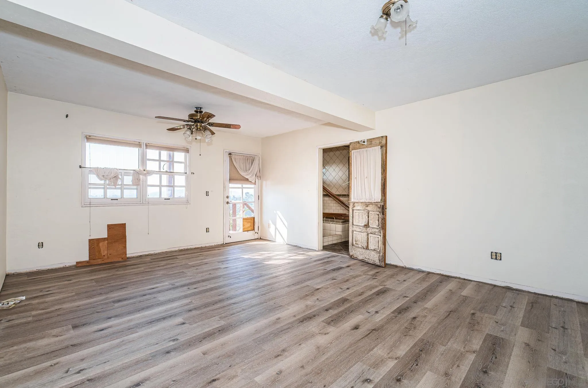 8046 Pasadena Avenue La Mesa, CA 91941 - Photo 18 of 32 an empty room with wooden floor and windows