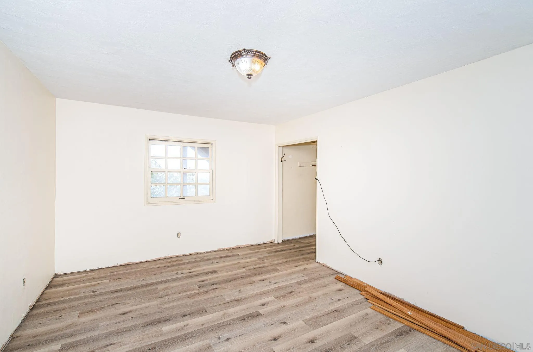 8046 Pasadena Avenue La Mesa, CA 91941 - Photo 19 of 32 an empty room with wooden floor and windows