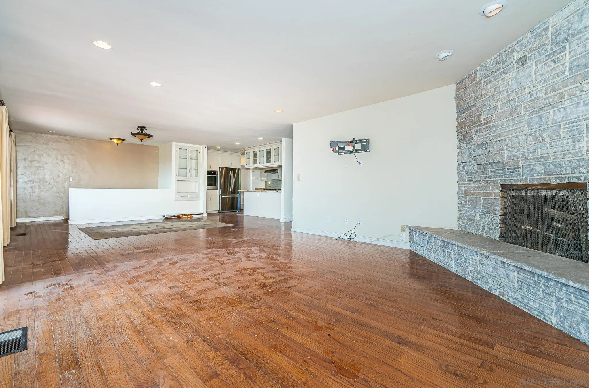 8046 Pasadena Avenue La Mesa, CA 91941 - Photo 6 of 32 an empty room with wooden floor and fireplace