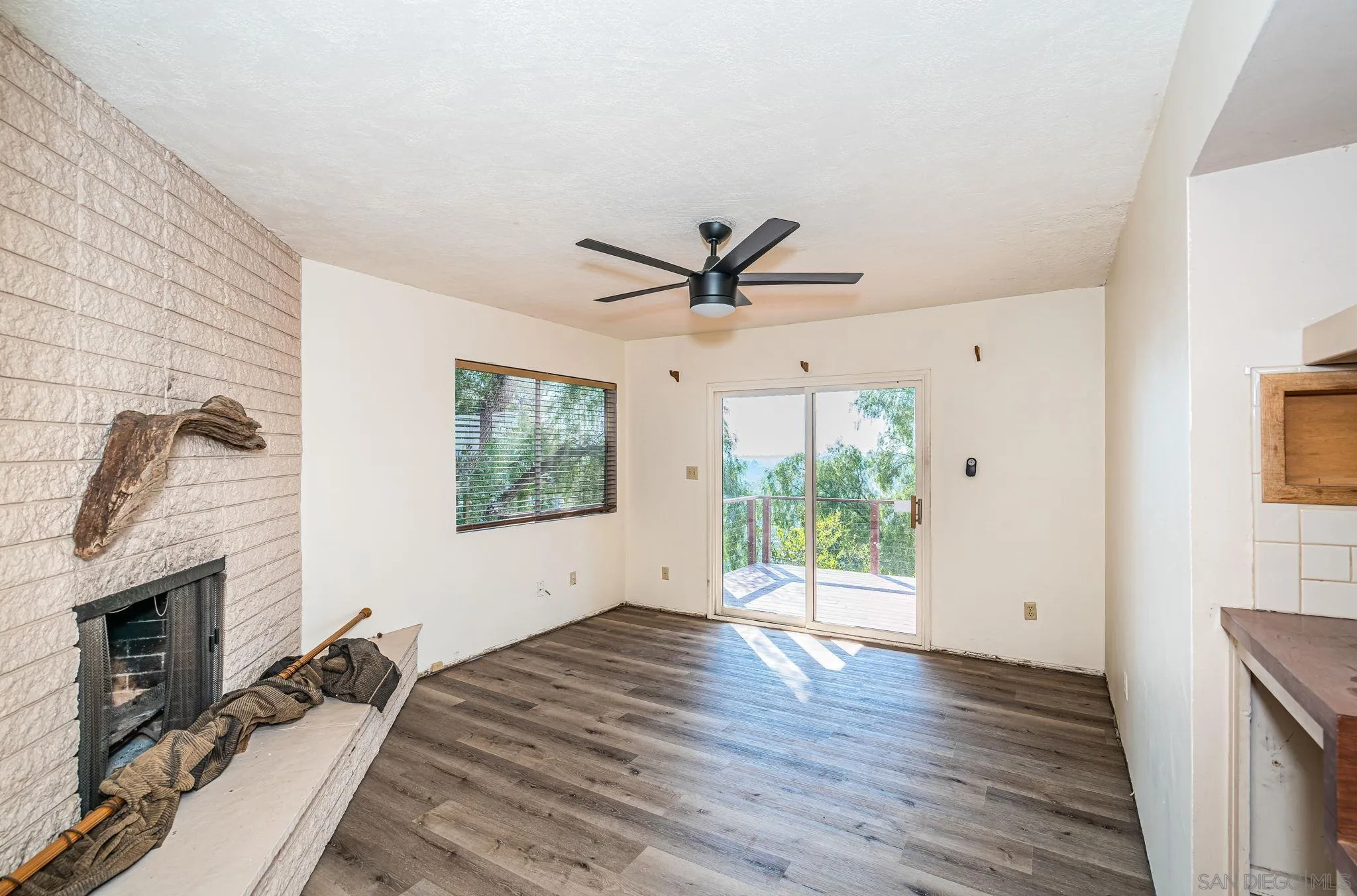 8046 Pasadena Avenue La Mesa, CA 91941 - Photo 8 of 32 a view of a livingroom with wooden floor and a ceiling fan