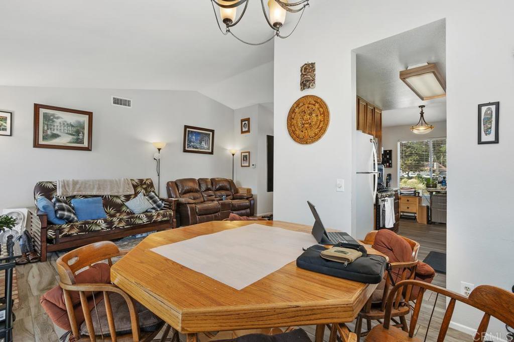 4616 Arrowhead Court Oceanside, CA 92056 - Photo 16 of 50 a living room with dining table and a clock