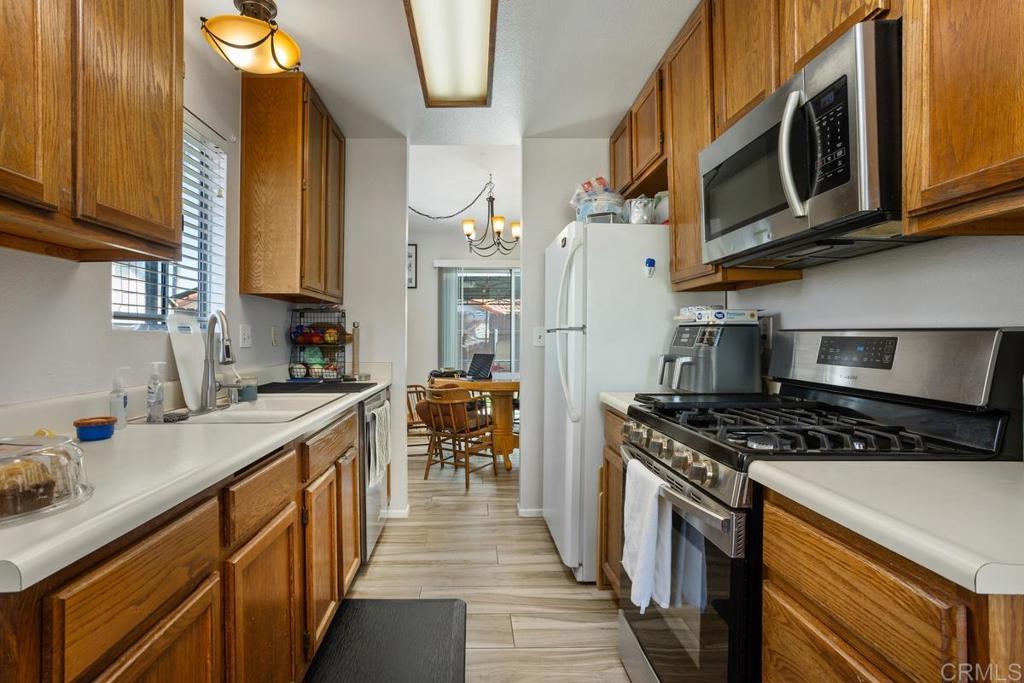 4616 Arrowhead Court Oceanside, CA 92056 - Photo 18 of 50 a kitchen with stainless steel appliances granite countertop a stove a sink and a microwave