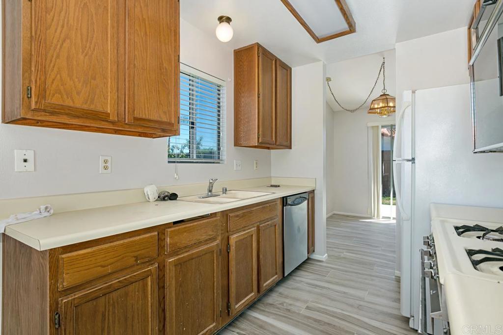 4616 Arrowhead Court Oceanside, CA 92056 - Photo 20 of 50 a kitchen with a sink and a refrigerator