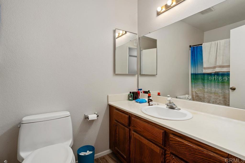 4616 Arrowhead Court Oceanside, CA 92056 - Photo 26 of 50 a bathroom with a sink vanity mirror and toilet