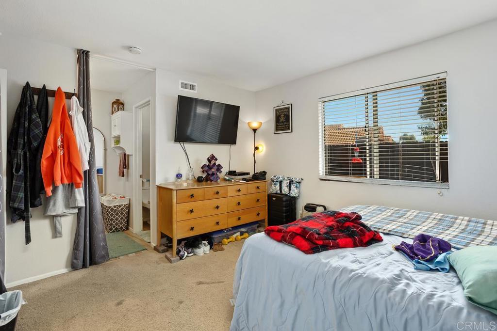 4616 Arrowhead Court Oceanside, CA 92056 - Photo 28 of 50 a bedroom with a bed and a flat screen tv