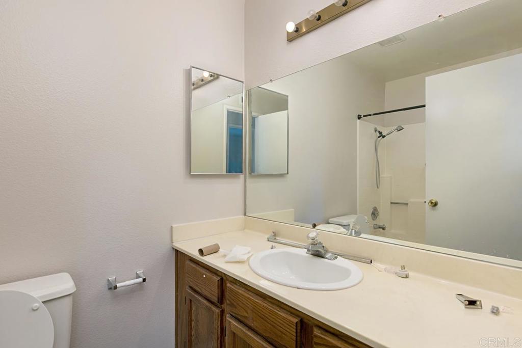 4616 Arrowhead Court Oceanside, CA 92056 - Photo 32 of 50 a bathroom with a sink and a mirror