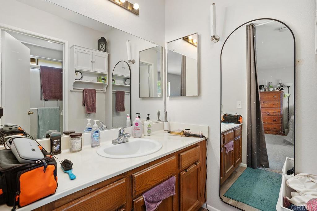 4616 Arrowhead Court Oceanside, CA 92056 - Photo 33 of 50 a bathroom with a sink vanity and mirror